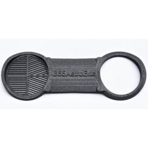 Black plastic tool with two circular ends.