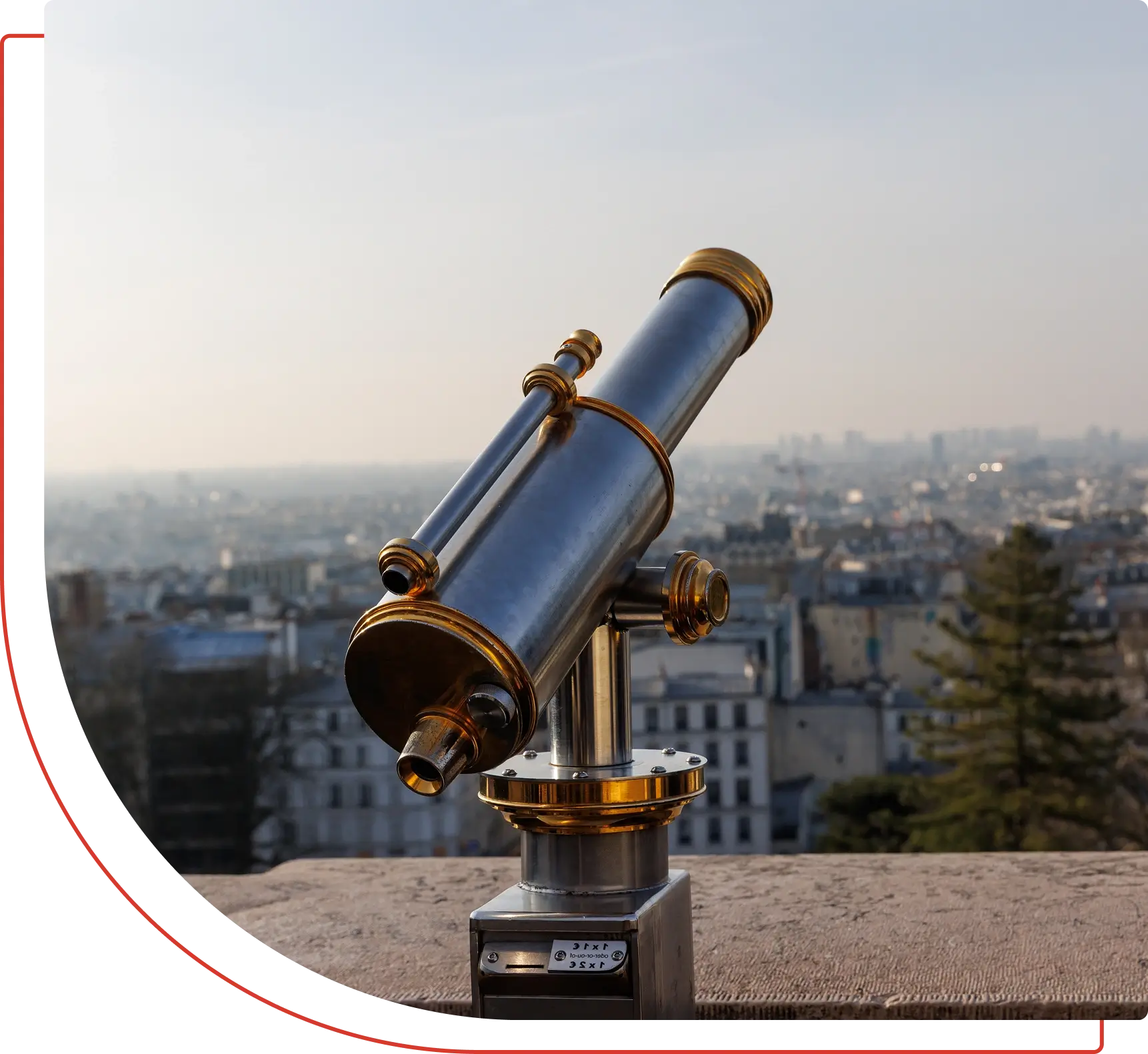 Telescope overlooking a cityscape with trees.