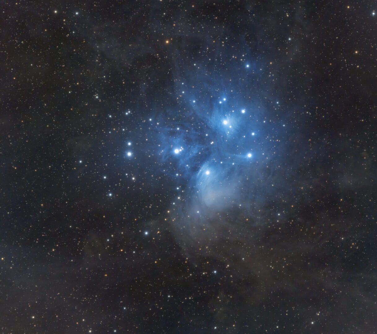Starry night sky with bright blue nebula.
