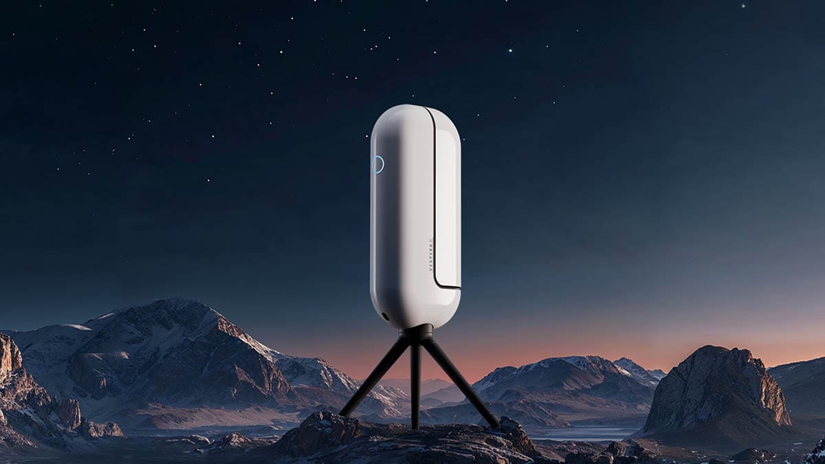 Futuristic white device on tripod in a mountainous night landscape.