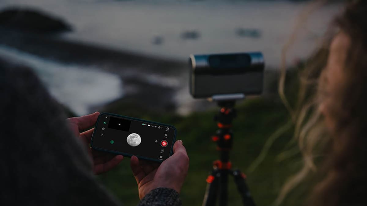 Person controls a camera mounted on a tripod with a smartphone.