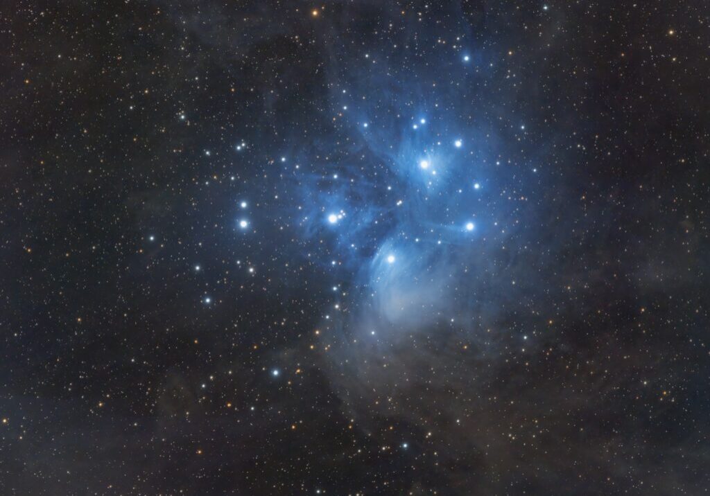 Starry night sky with bright blue nebula.